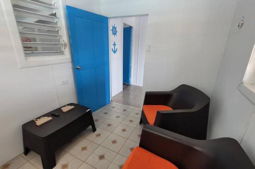 a living room with two chairs and a table at Container 1 with pool, free wifi fully equiped in Cabo Rojo