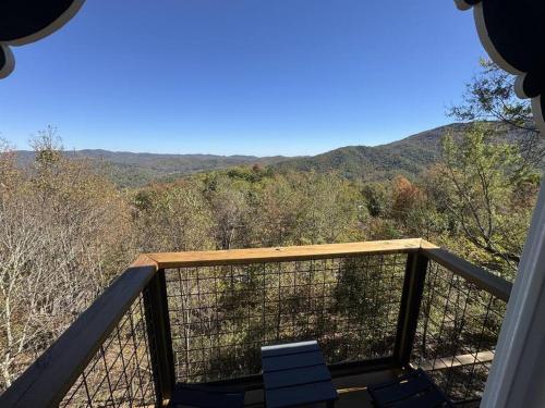 a balcony with a view of the mountains at 1MMView-2Kings-HotTub-PoolTable-Arcade-Waterfall in Seven Devils