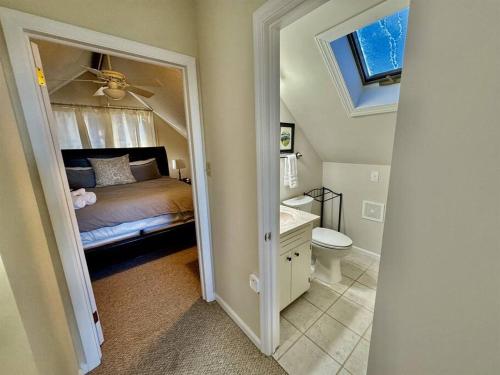 a bedroom with a bed and a sink and a toilet at 1MMView-2Kings-HotTub-PoolTable-Arcade-Waterfall in Seven Devils