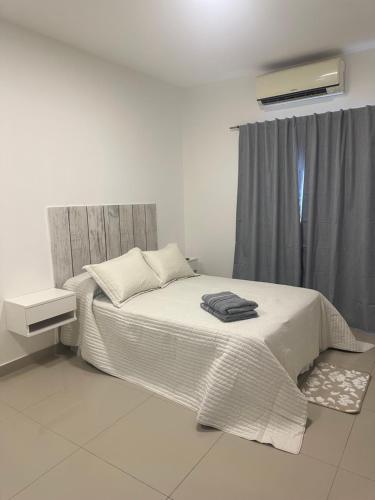 a bedroom with a bed and a window at Lo de Hugo in Muñiz