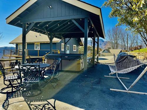 a picnic shelter with a table and chairs at 1MMView-2Kings-HotTub-PoolTable-Arcade-Waterfall in Seven Devils