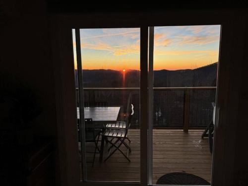 a view from a door of a balcony with a table at 1MMView-2Kings-HotTub-PoolTable-Arcade-Waterfall in Seven Devils