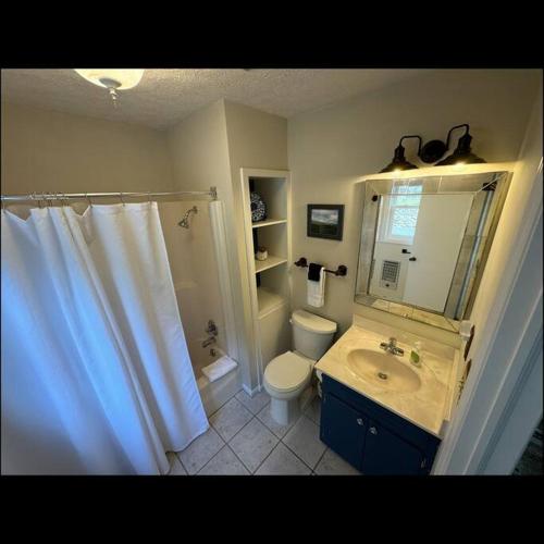 a bathroom with a sink and a toilet and a shower at 1MMView-2Kings-HotTub-PoolTable-Arcade-Waterfall in Seven Devils