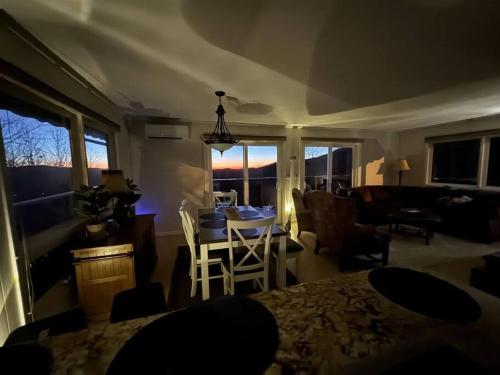 a living room with a table and chairs and a couch at 1MMView-2Kings-HotTub-PoolTable-Arcade-Waterfall in Seven Devils
