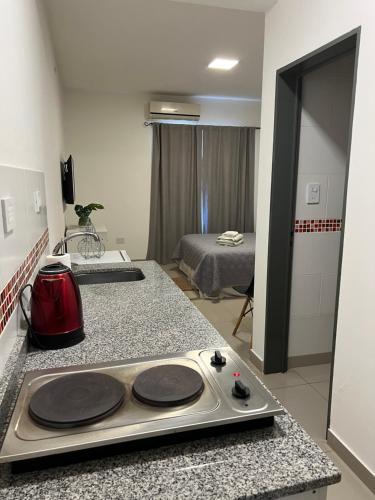 a kitchen with a stove top on a counter in a room at Lo de Hugo in Muñiz