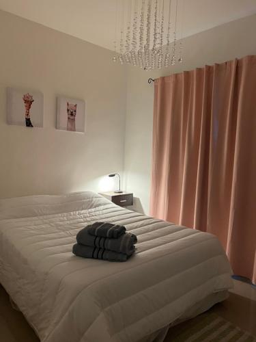 a bedroom with a bed with a towel on it at Lo de Hugo in Muñiz