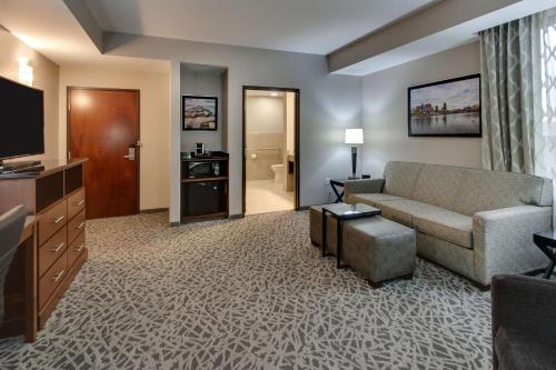 a living room with a couch and a television at Drury Plaza Hotel Milwaukee Downtown in Milwaukee