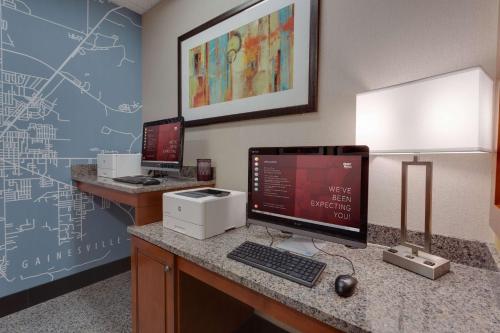 a room with two computer monitors on a desk at Drury Inn & Suites Gainesville in Gainesville