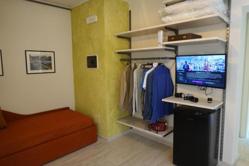 a living room with a tv and a couch and a room with at La Foresteria della Beppa in Zeri