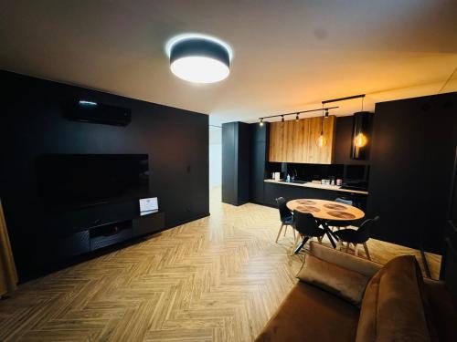 a living room with a table and a couch at Apartament Plaza Tower 2 in Kielce