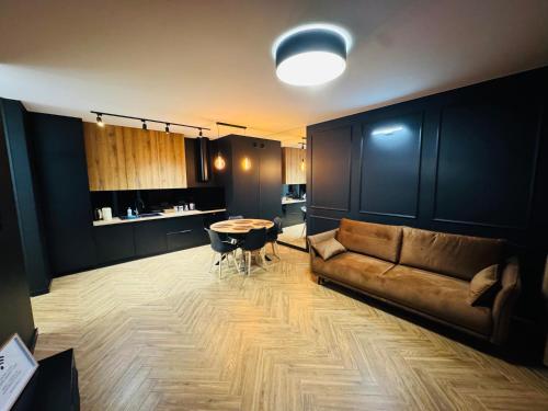 a living room with a couch and a table at Apartament Plaza Tower 2 in Kielce