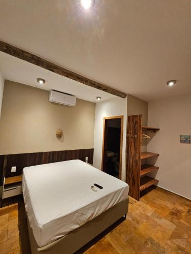 a bedroom with a bed and a staircase in it at Chalés Mahalo J - Pontal de Maceió - Fortim in Fortim