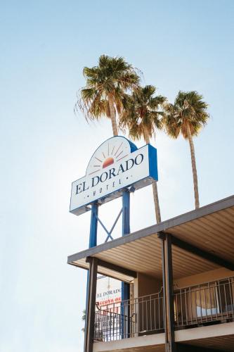a sign on top of a building with palm trees at Hotel El Dorado in Tecate