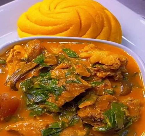 a bowl of food on a plate with a bowl of squash at Hotel De Alommah Kubwa Abuja in Abuja
