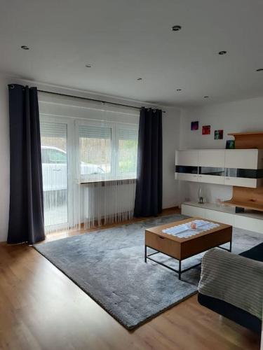 a living room with a couch and a coffee table at Appartement im bayerischen Wald in Untermitterdorf
