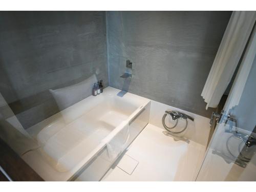 a bathroom with a white tub and a sink at Hotel Discover Nagaokakyo - Vacation STAY 29771v in Nagaokakyo