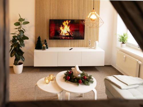 a living room with a fireplace and a tv at Schlosskönig - Modernes & zentrales Apartment mit Balkon und Arbeitsplatz in Schwerin