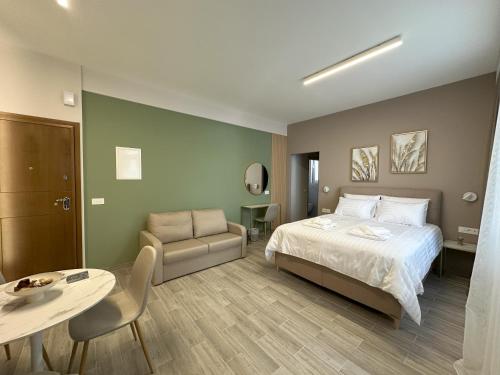 a bedroom with a bed and a table and a chair at CityLuxe Center Ioannina in Ioannina