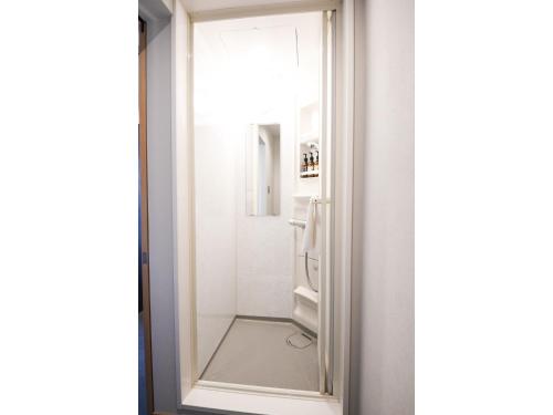 a bathroom with a mirror next to a shower at Hotel Discover Nagaokakyo - Vacation STAY 29764v in Nagaokakyo