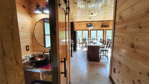 a kitchen and dining room of a log home at Lux Cabin Indoor and Outdoor Living in Sevierville