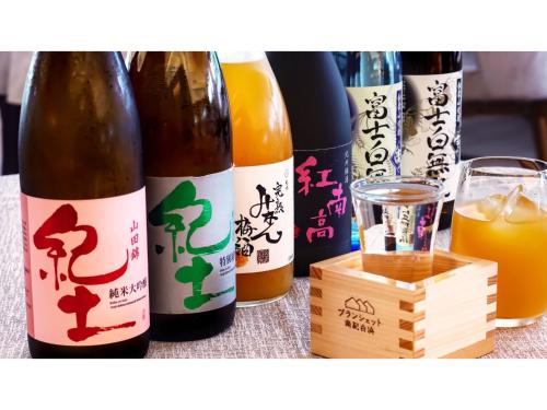 a group of bottles of wine and a glass of orange juice at Blanchette Nankishirahama - Vacation STAY 05733v in Kanayama