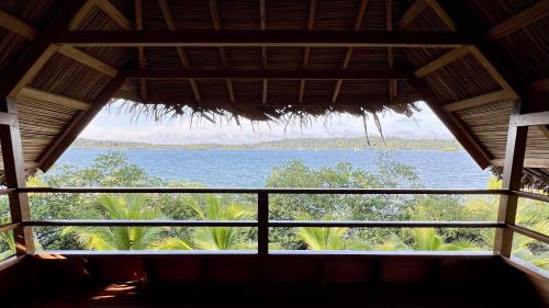 a view from the inside of a building looking out at the water at Akwaba Lodge in The Gap