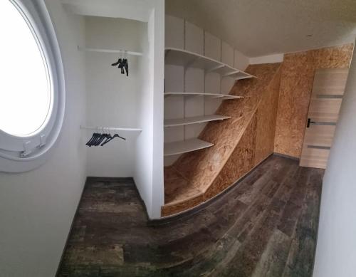 a room with a staircase with shelves and a window at Maison familiale 6 pers ,1 bébé in Étaples