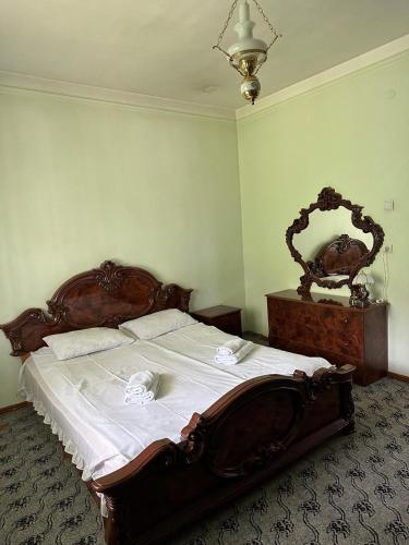 a bedroom with a large wooden bed and a mirror at Holiday Home in Tʼeghut