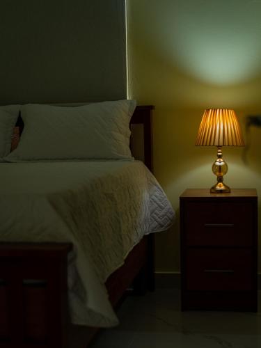 a bedroom with a bed and a lamp on a night stand at Villas Vallejuelo in Vallejuelo