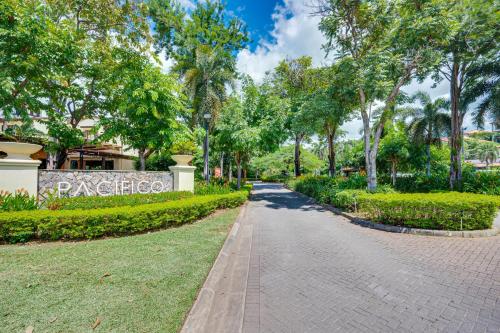 a brick path in a park with trees at Pacifico Townhouse 106 in Coco