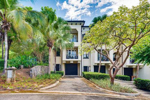 an exterior view of a building with palm trees at Pacifico Townhouse 106 in Coco