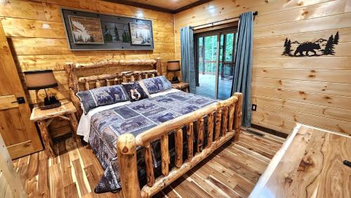 a bedroom with a bed in a log cabin at Lux Cabin Indoor and Outdoor Living in Sevierville