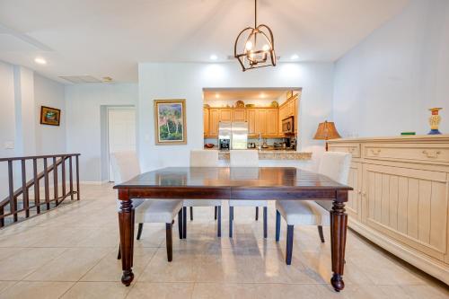 a dining room with a wooden table and white chairs at Pacifico Townhouse 106 in Coco