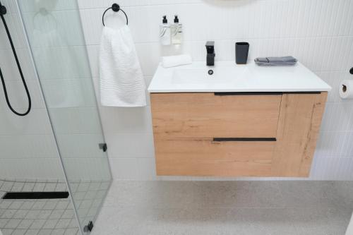 a bathroom with a sink and a shower at High Hedges Guest Suites Constantia in Cape Town
