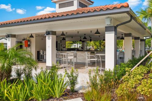 a pavilion with a table and chairs on a patio at Cozy Condo wPrivate Balcony & FREE Resort Access in Orlando