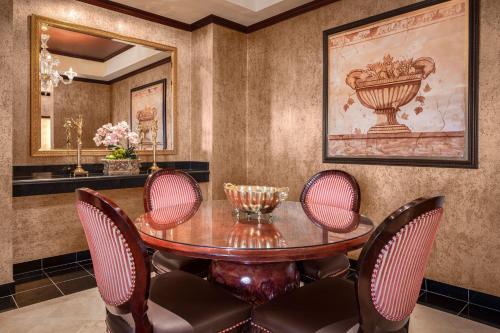 a dining room with a table and chairs at Silver Legacy Reno, A Caesars Destination in Reno