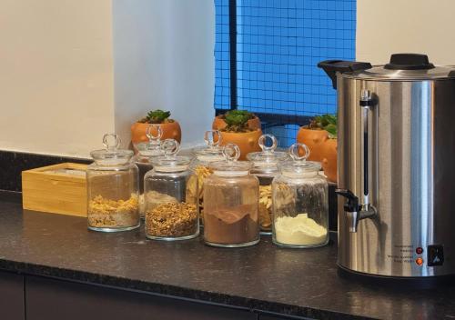 a group of jars filled with food on a counter at Nord One in João Pessoa