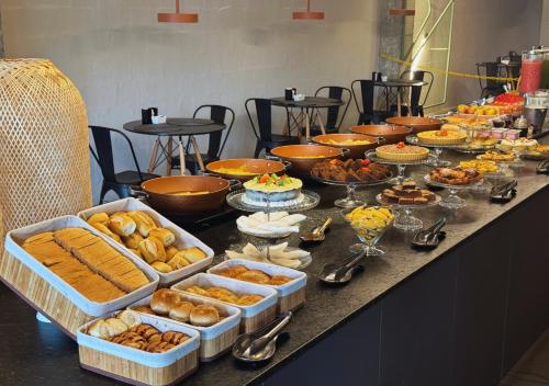 a buffet with many different types of food on a table at Nord One in João Pessoa