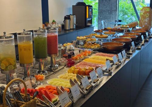 a buffet line with many different types of food at Nord One in João Pessoa