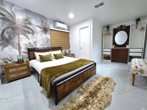 a bedroom with a bed and a palm tree mural at Sunset Retreat at Heart of Miami with pool in Miami