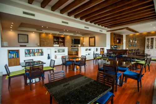 a restaurant with tables and chairs in a room at Puerto Vallarta Del Canto Luxury in Bucerías