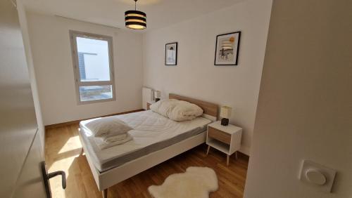 une petite chambre avec un lit et une fenêtre dans l'établissement Modern and Comfortable 2-bedroom apartment near the center, à Divonne-les-Bains