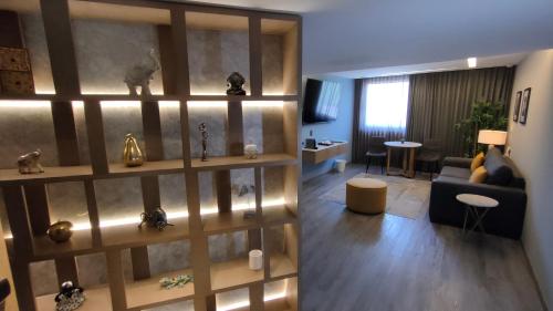 a living room with a large wooden book shelf at Alia Inn Boutique WTC in Mexico City