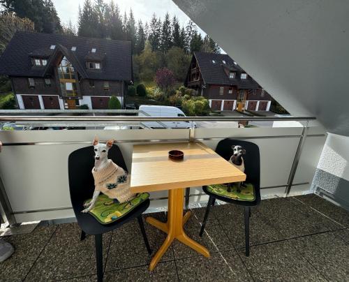 a small table and two chairs on a balcony at Ferienhaus Frei 4 Compact in Hinterzarten