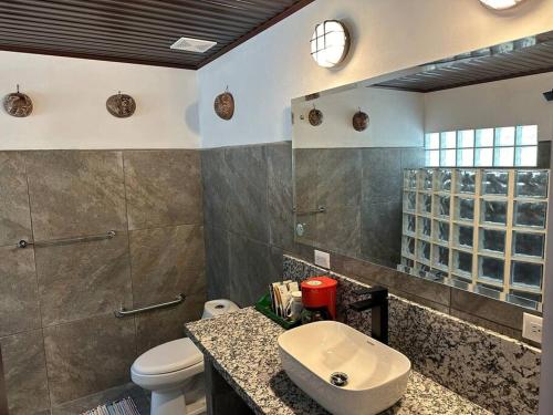 a bathroom with a sink and a toilet at Refugio La Montaña, Costa Rica, Chic Retreat and Pool in San Vito