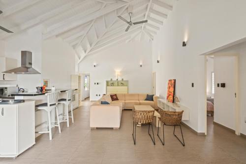 a kitchen and living room with a couch and a table at Villa Rubio in Grote Berg