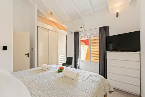 a bedroom with a bed and a flat screen tv at Villa Rubio in Grote Berg
