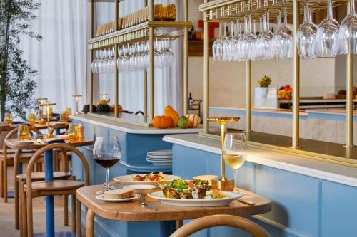 a restaurant with a table with food and wine glasses at The Westin Brisbane in Brisbane