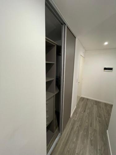a walk in closet with a glass door at APART Caballito II in Buenos Aires