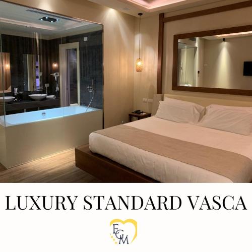 a hotel room with a bed and a bath tub at Emotional Grand Motel in Fontaneto dʼAgogna